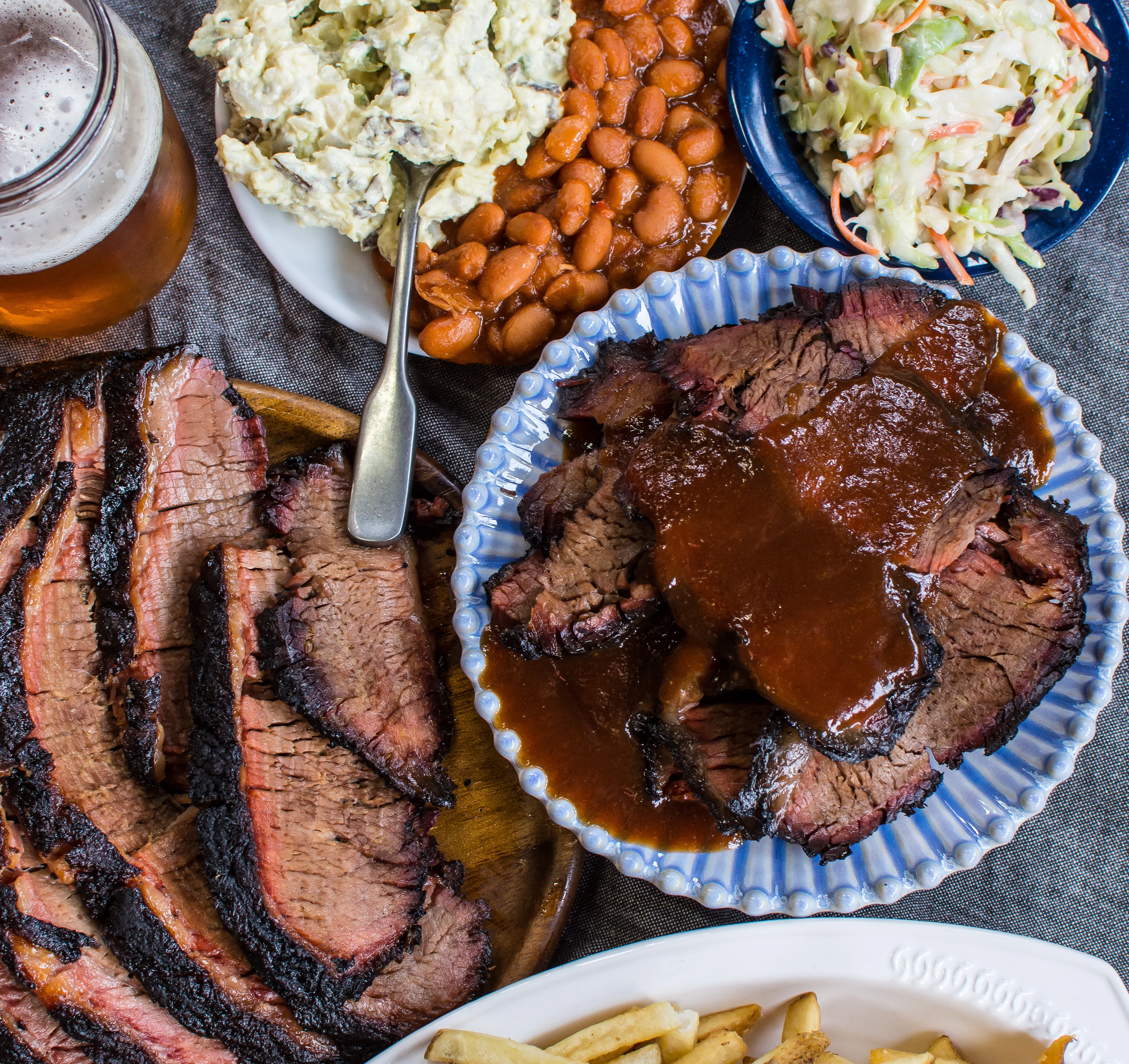 barbecue catering spread of brisket and sides